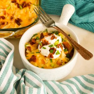 Close up of Chicken Hashbrown Casserole in a bowl with a fork.
