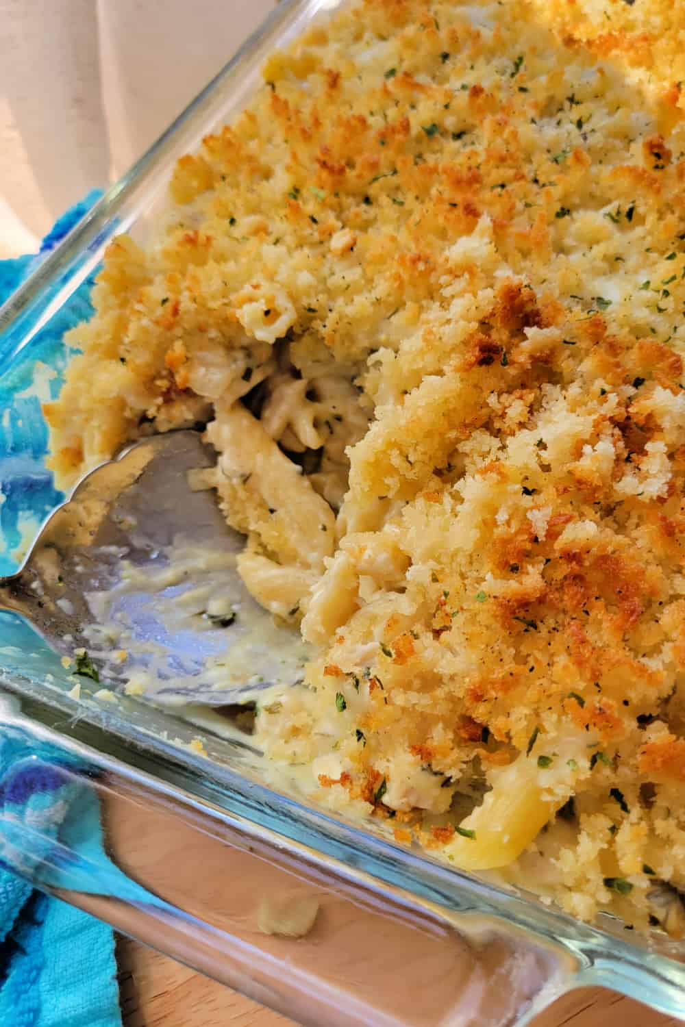 Creamy Chicken Pasta Casserole in a baking dish with a spoon.