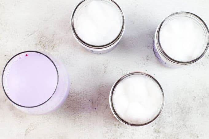 glass of the lightest purple paint by the jars