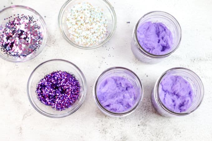 Cotton in jars has now been dyed purple - glitter in bowls to the side