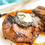 Close up of Grilled Top Sirloin Steak with compound butter on top.