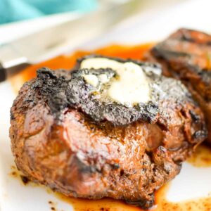 Close up of Grilled Top Sirloin Steak with compound butter on top.