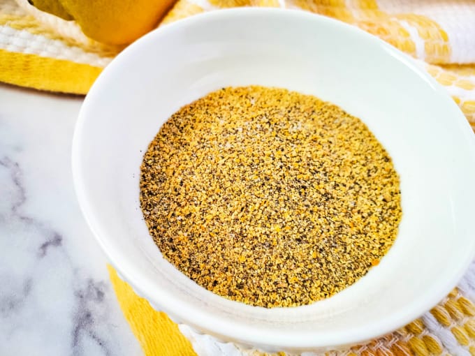 Top down view of lemon pepper seasoning in a small bowl.