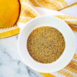Top down view of lemon pepper seasoning in a small bowl.