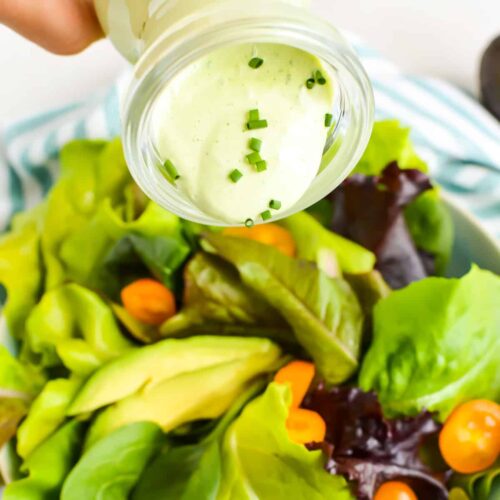 Close up of Avocado Ranch Dressing being poured onto salad.