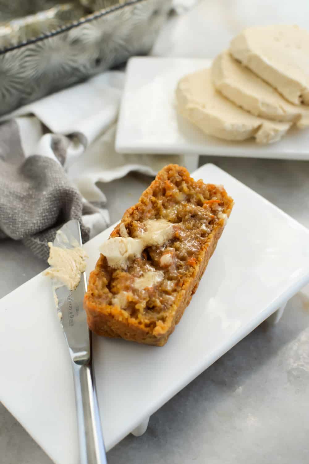 Close up of carrot bread on a white plate with Brown Sugar Butter.