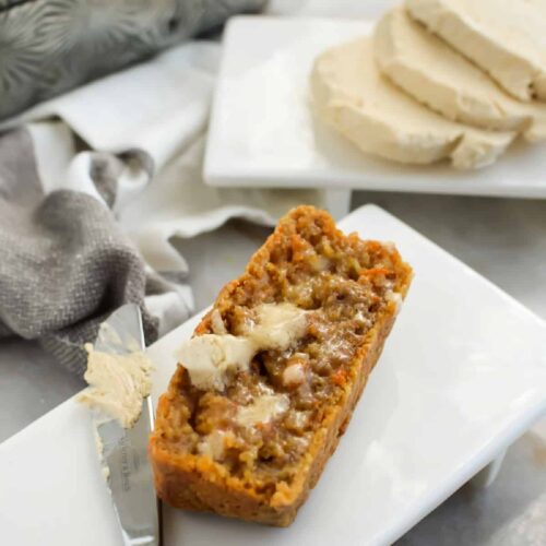 Close up of carrot bread on a white plate with Brown Sugar Butter.