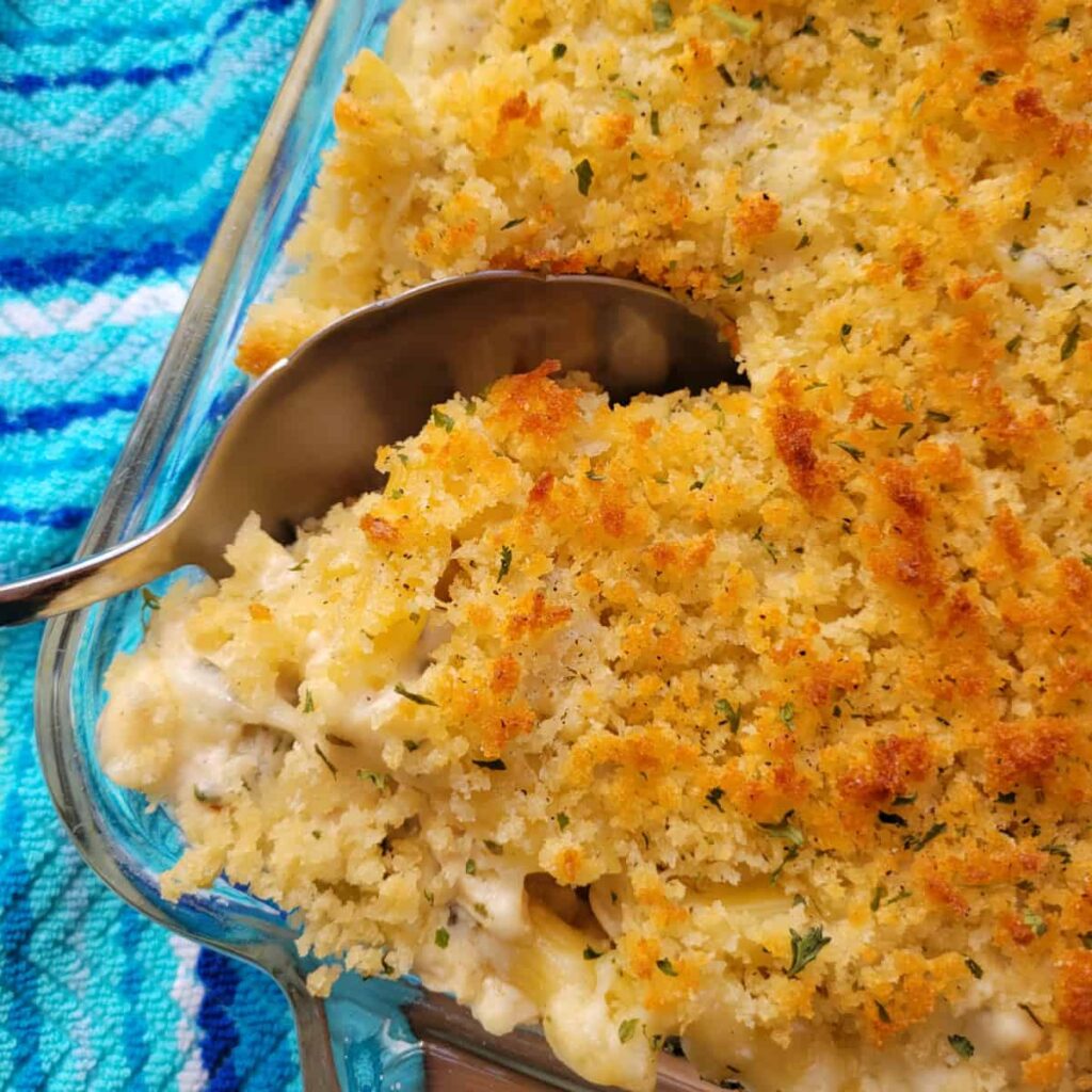 Close up of Creamy Chicken Pasta Bake with a serving spoon.