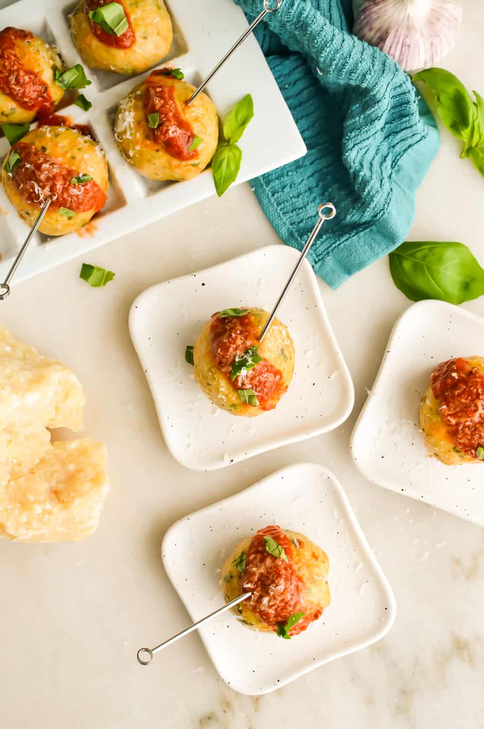 Vertical image of Keto Chicken Meatballs on small appetizer plates.