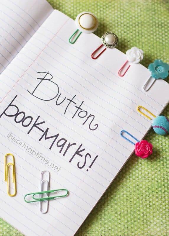 Button bookmarks made using paperclips and buttons clipped to a notebook page.