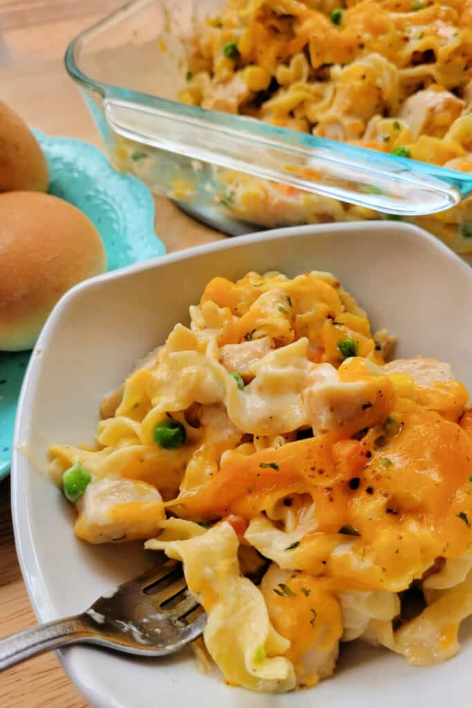 Close up of easy Chicken Noodle Casserole in a bowl with a fork.