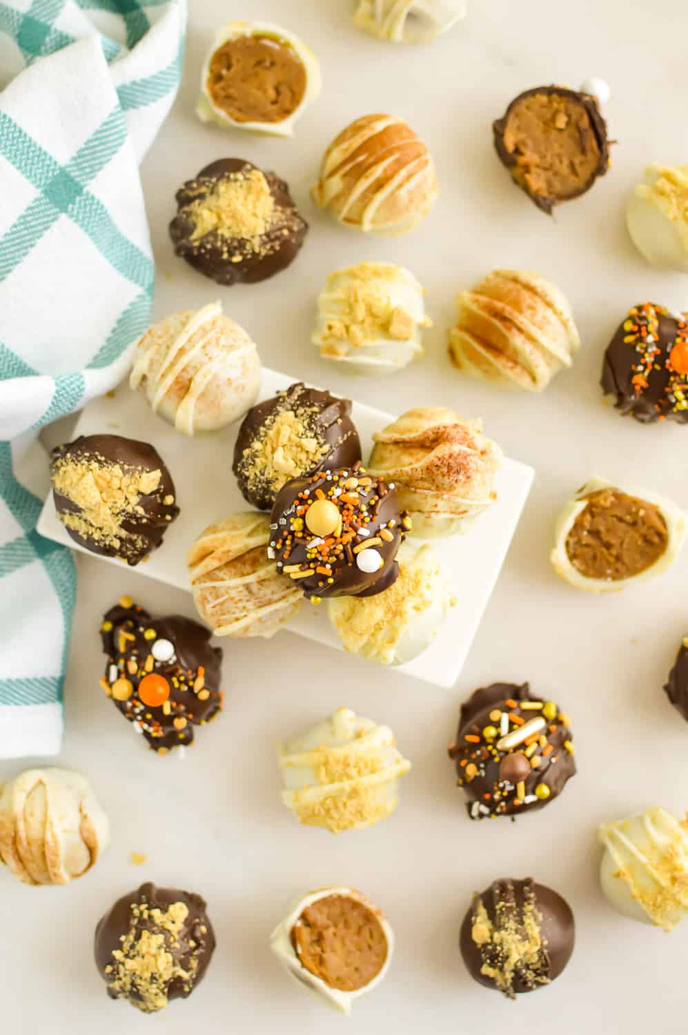 A variety of Pumpkin Cream Cheese Cake Balls on a counter top.