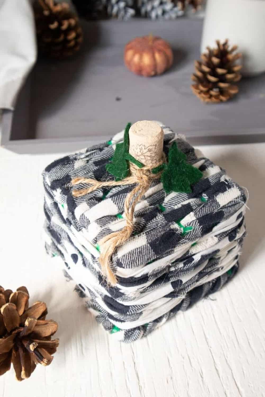 Vertical image of Upcycled Basket Pumpkin made with buffalo chicken fabric and a wine cork.