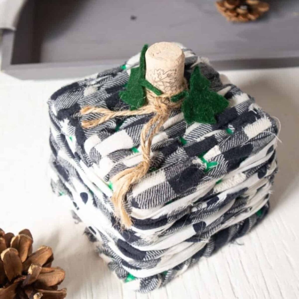 Close up of Upcycled Basket Pumpkin made with buffalo chicken fabric and a wine cork.