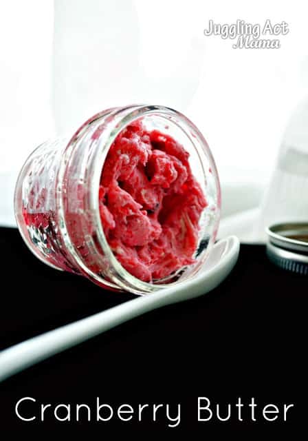 Small jar of cranberry butter compound with a spoon.
