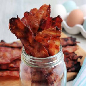 Close up of Grilled Bacon in a mason jar.