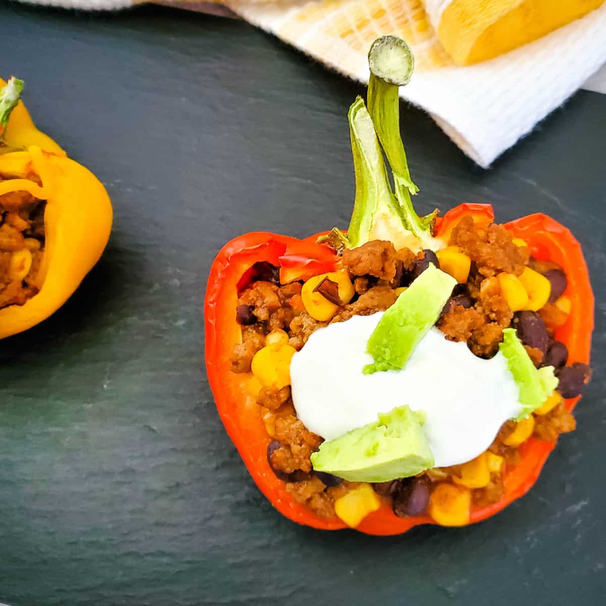 Mexican Stuffed Peppers on black slate background.