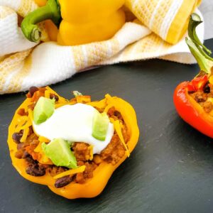Taco Stuffed Peppers on black slate background.