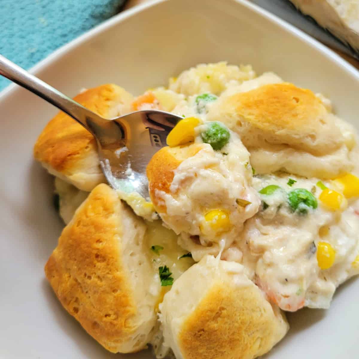 Close up of Chicken Bubble Biscuit Casserole with a spoon.
