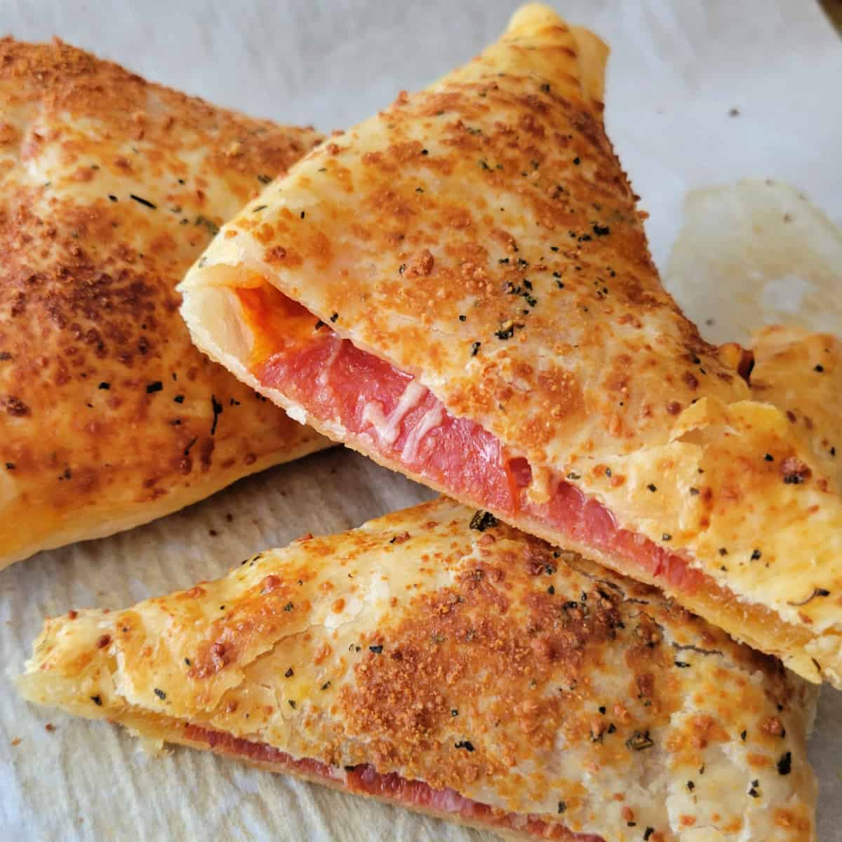 Close up of Puff Pastry Pizza Pockets on a baking sheet.