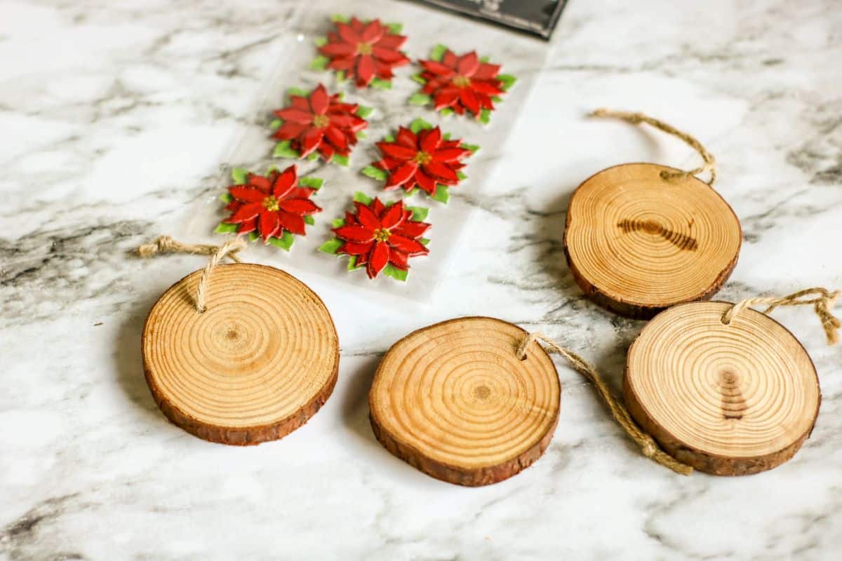 Materials needed for making Wood Slice Poinsettia Ornaments.