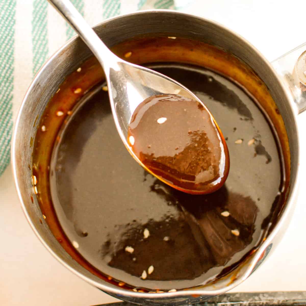 Close up of a spoon with Teriyaki Sauce on it.