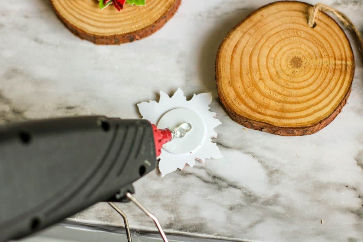 Steps showing how to make Wood Slice Poinsettia Ornaments.