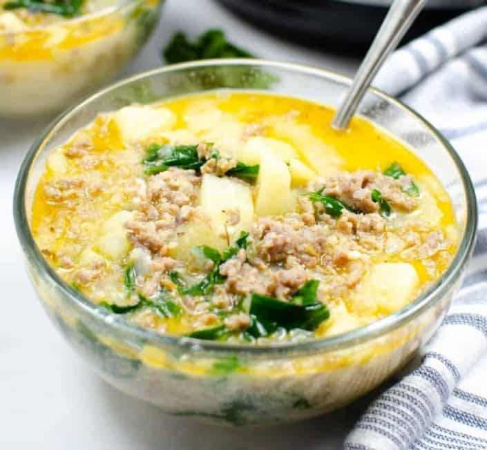 Bowl of Zuppa Toscana with a spoon.