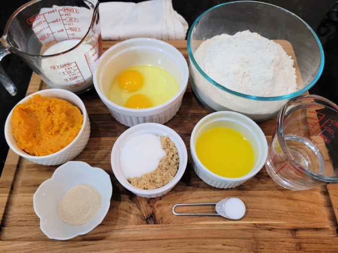 Sweet Potato Roll Ingredients in bowls and measuring cups on a cutting board.