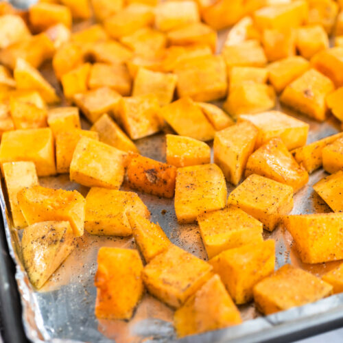 Close up of butternut squash on a baking pan.