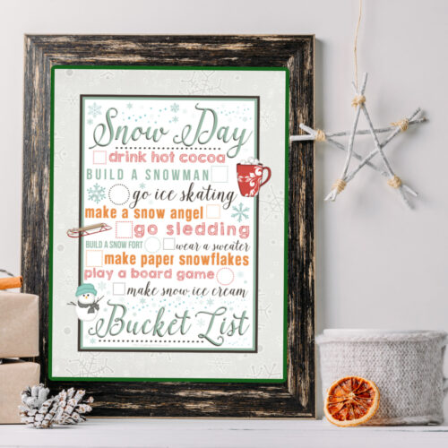 Close up of Snow Day Bucket List Framed on a shelf with knick knacks.