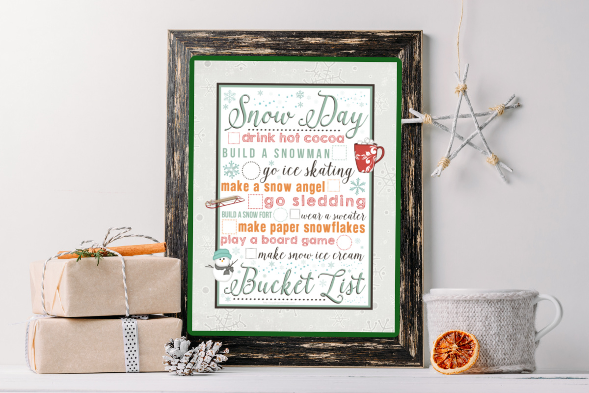 Snow Day Bucket List Framed on a shelf with knick knacks.