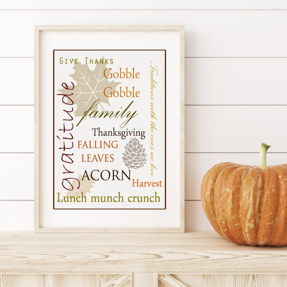 Framed Thanksgiving Printable on a mantle with a pumpkin.