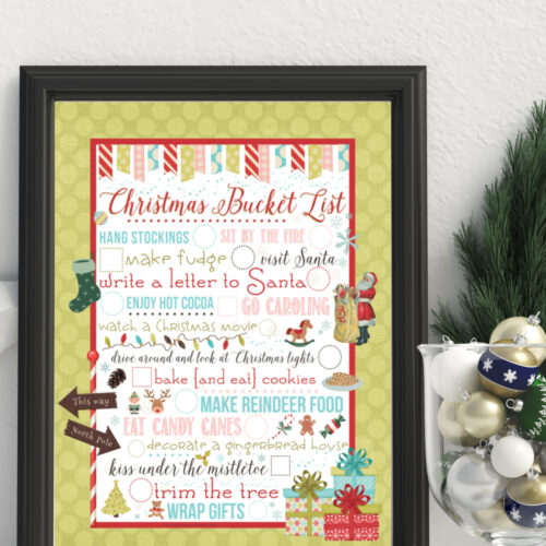 Framed Christmas Bucket List Printable on a shelf next to holiday decor.