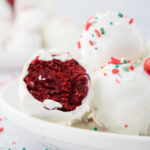 Plate full of Red Velvet Cake Balls decorated for the holidays