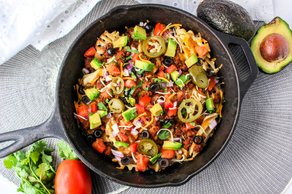 Top down view of Waffle Fry Nachos in cast iron skillet