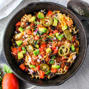 Close up of Waffle Fry Nachos in cast iron skillet.