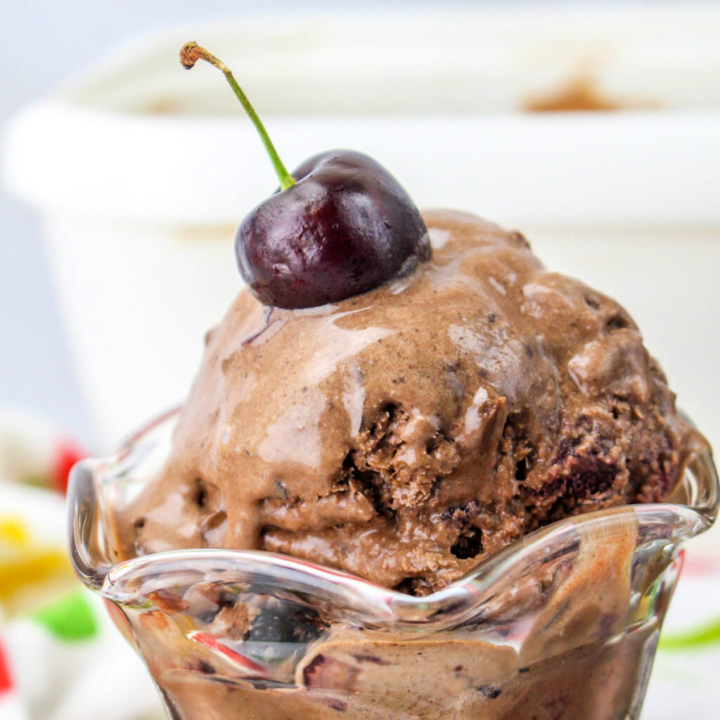 Close up Black Forest Ice Cream with a cherry on top.