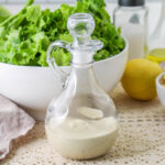 Caesar Dressing Without Anchovies in a cruet with stopper.