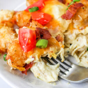 Close up of Chicken Bacon Ranch Tator Tot Casserole on a plate with a fork.