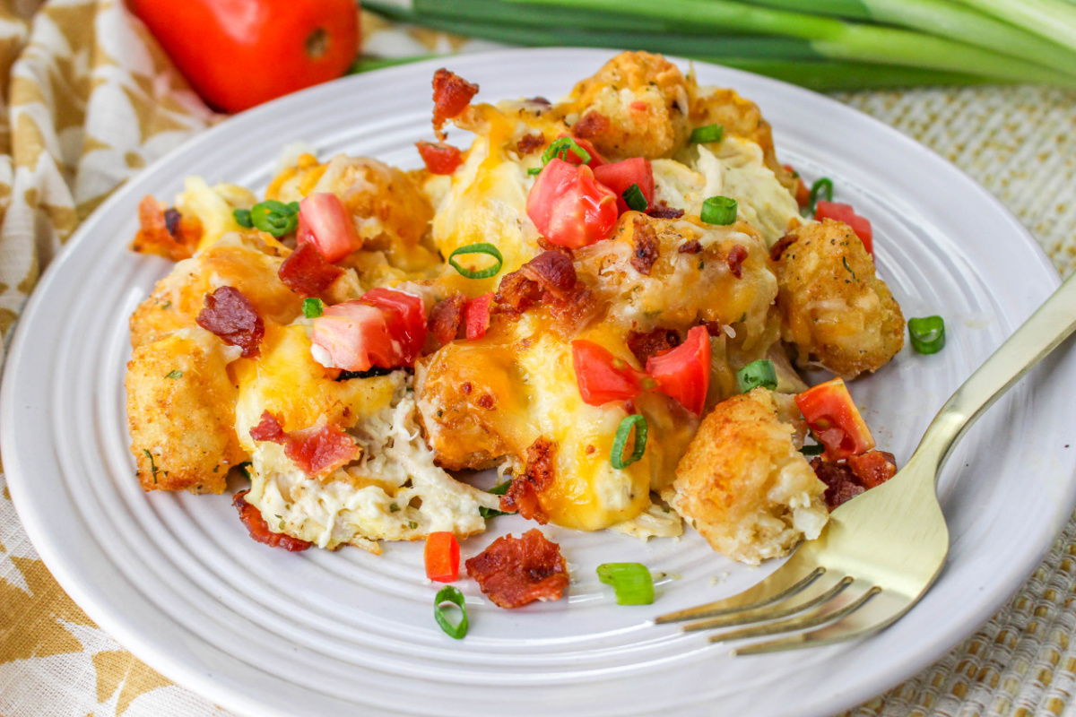 Close up of Chicken Bacon Ranch Tator Tot Casserole on a plate with a fork.