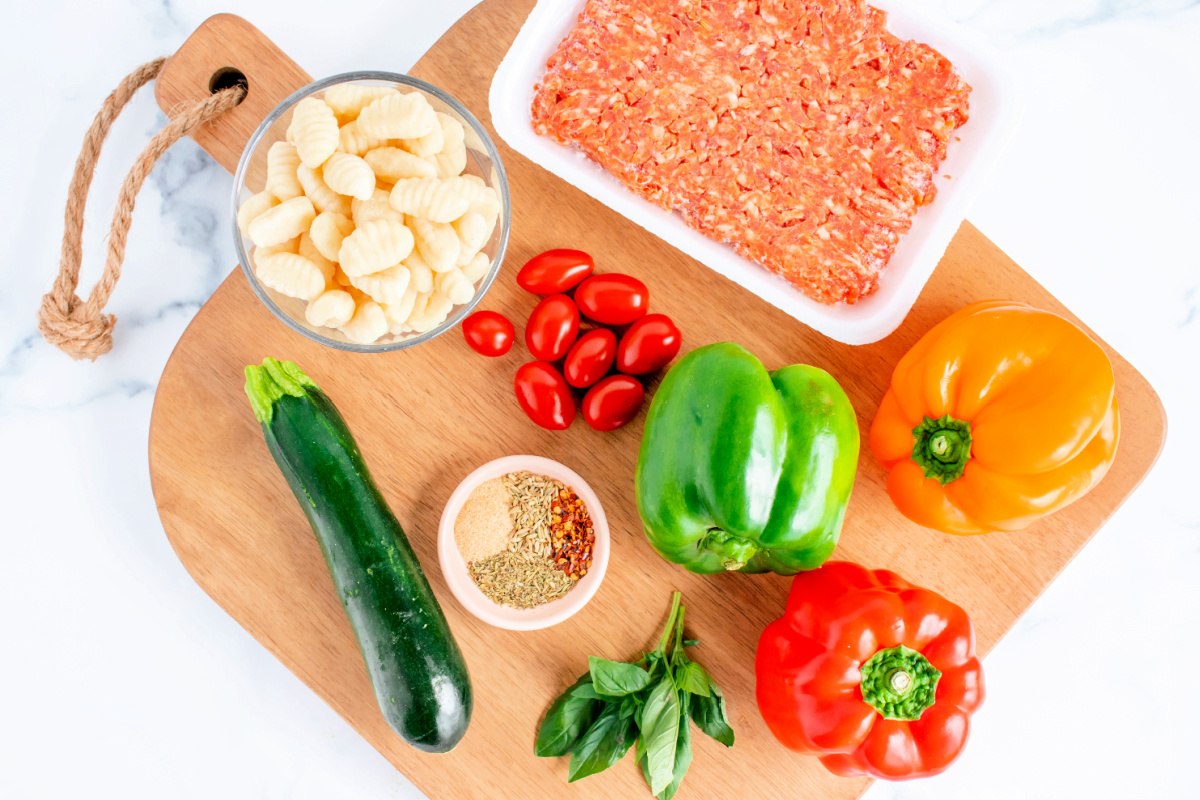Italian Sausage Gnocchi Bake Ingredients including peppers, zucchini, and tomatoes.