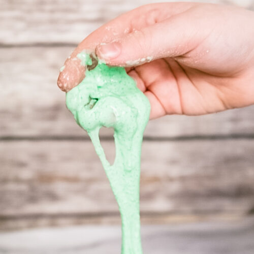 Child's hand holding Jello Slime.