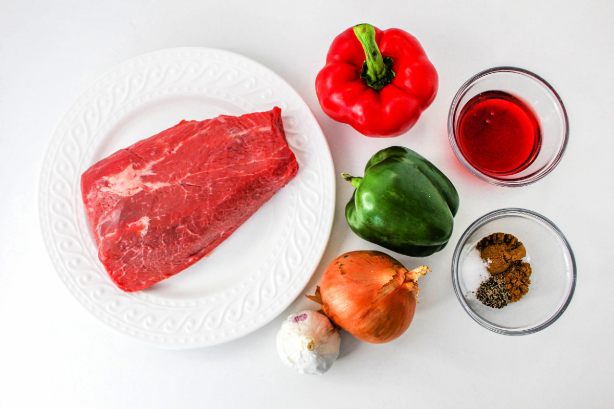 Shredded Beef Enchiladas Ingredients including peppers and onions.
