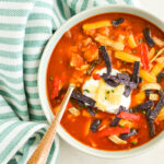 Top down view of Chicken Tortilla Soup in a bowl with a spoon.