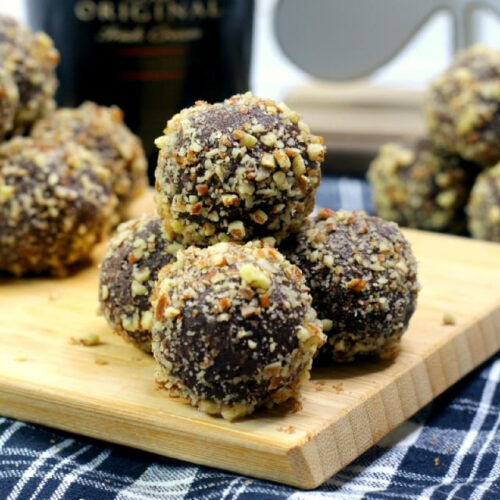 Bailey's Truffles with hazlenuts on a cutting board.