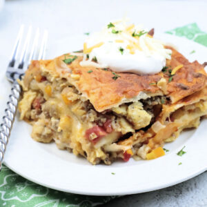 Close up of Breakfast Enchilada Casserole on a plate with a fork.