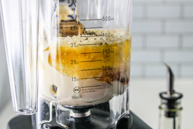 Blender with ingredients for making Caesar Dressing Without Anchovies.