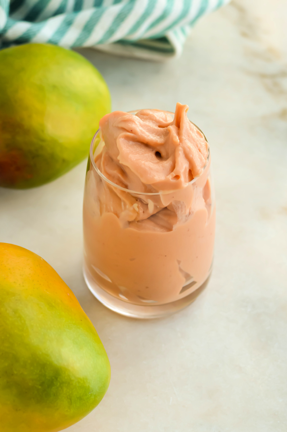 Creamy Strawberry Mango Smoothie in a small glass.