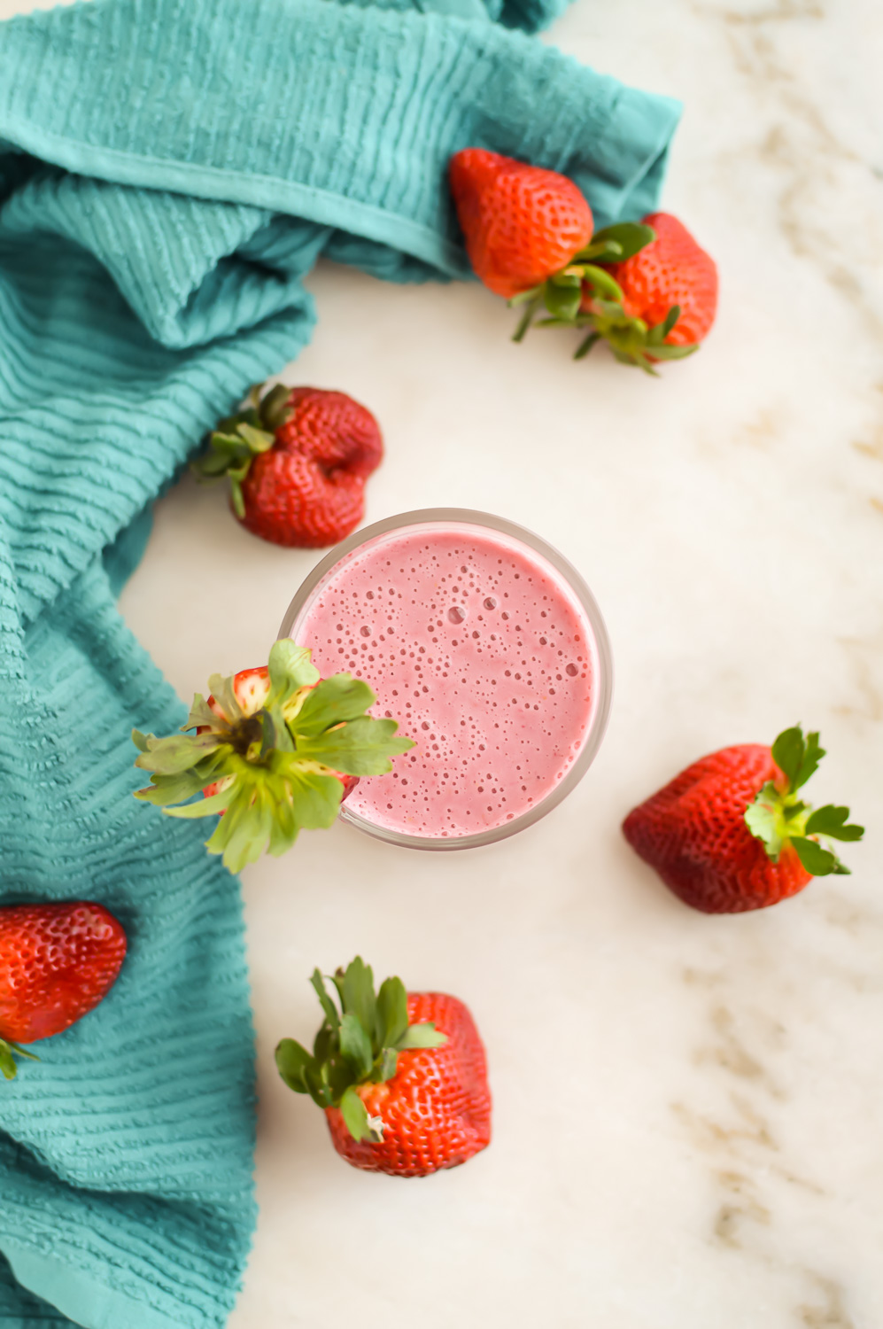 Top down view of Strawberry Banana Smoothie in a small glass.